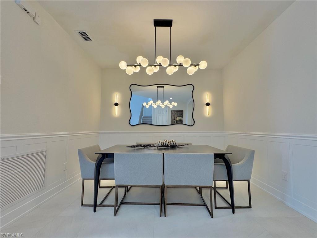 12667 Biscayne Court Naples, FL 34105 - Photo 11 of 39 a view of a dining room with furniture
