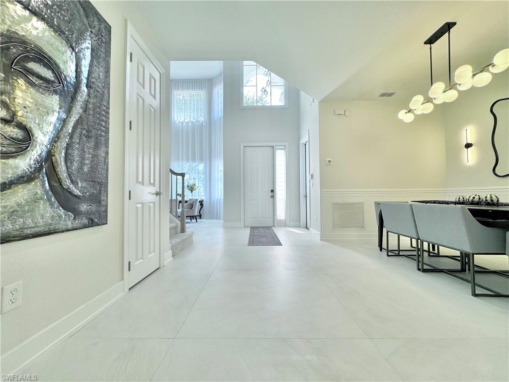 12667 Biscayne Court Naples, FL 34105 - Photo 13 of 39 a view of a livingroom with a furniture and floor to ceiling window