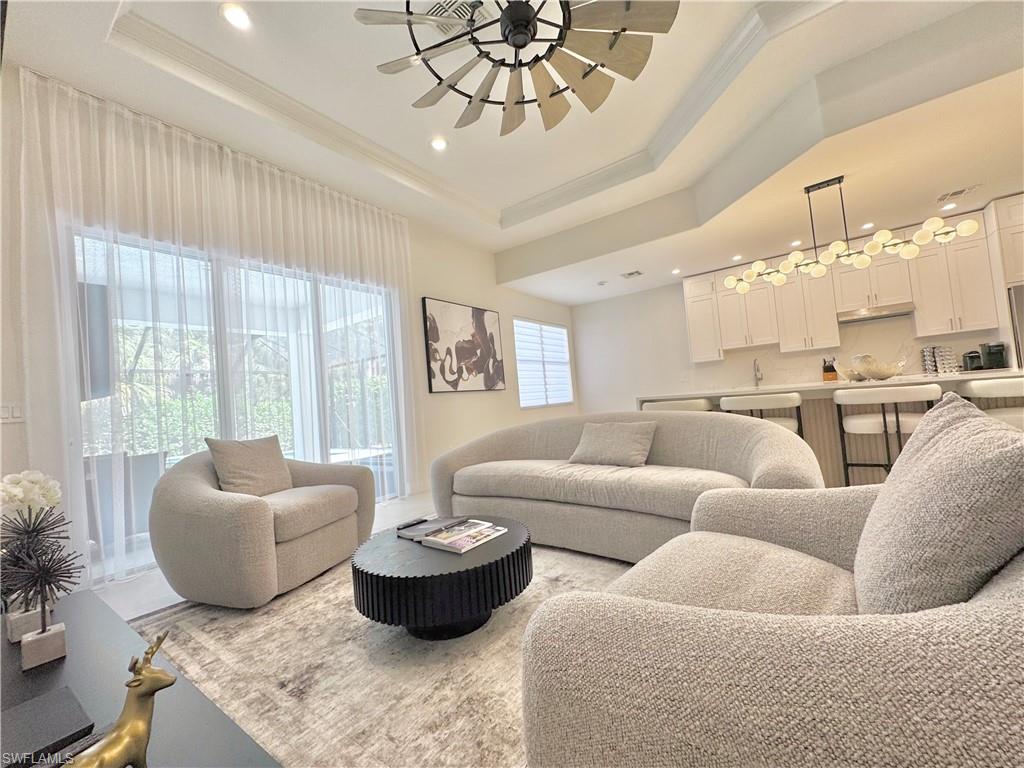 12667 Biscayne Court Naples, FL 34105 - Photo 25 of 39 a living room with furniture and a large window