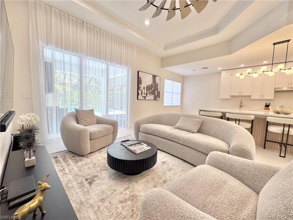 12667 Biscayne Court Naples, FL 34105 - Photo 26 of 39 a living room with furniture and a large window