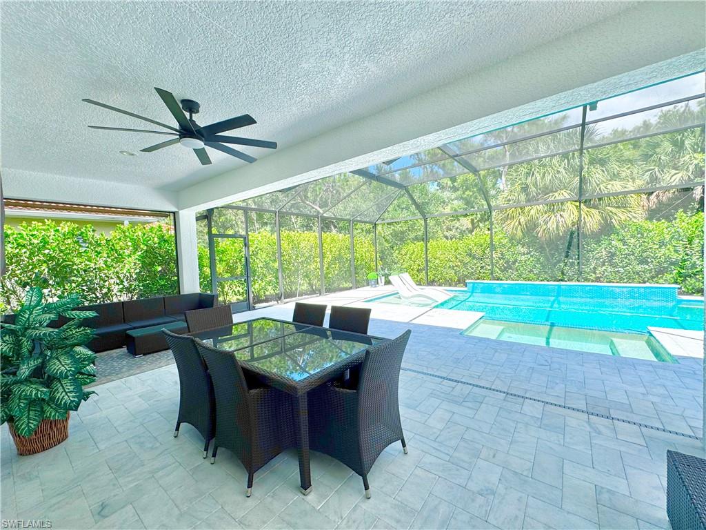 12667 Biscayne Court Naples, FL 34105 - Photo 32 of 39 a dining room with furniture and a floor to ceiling window