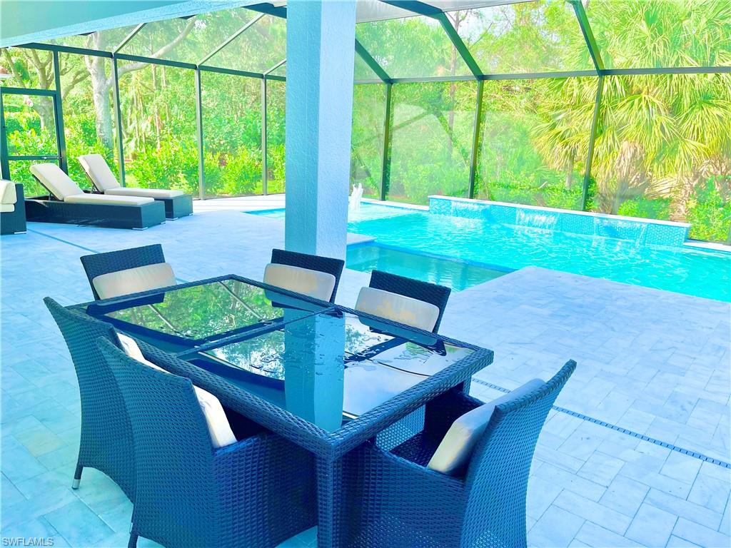 12667 Biscayne Court Naples, FL 34105 - Photo 37 of 39 a view of a dining room with furniture window and outside view