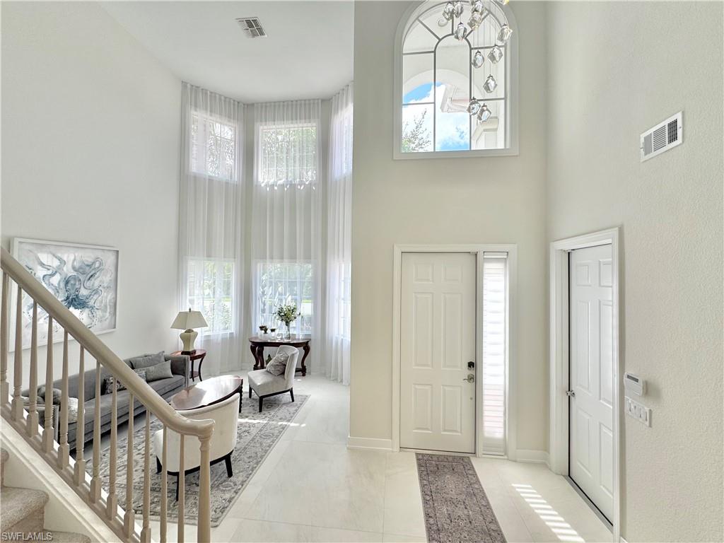 12667 Biscayne Court Naples, FL 34105 - Photo 6 of 39 a living room with furniture and a window
