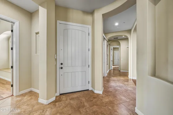 a view of a hallway with wooden shelves