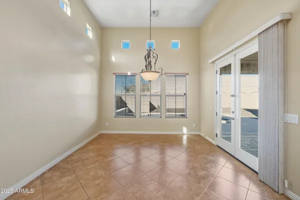a view of a room with wooden floor and chandelier