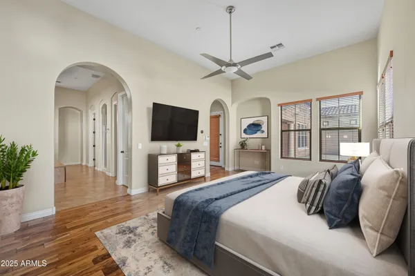 a spacious bedroom with a large bed and a flat screen tv