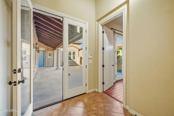 a view of a hallway with wooden floor and closet