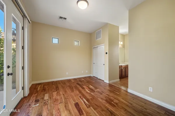 a view of empty room with wooden floor
