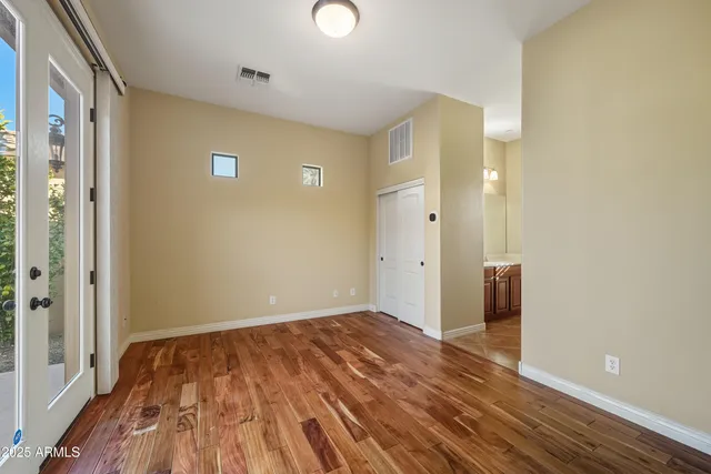 a view of empty room with wooden floor