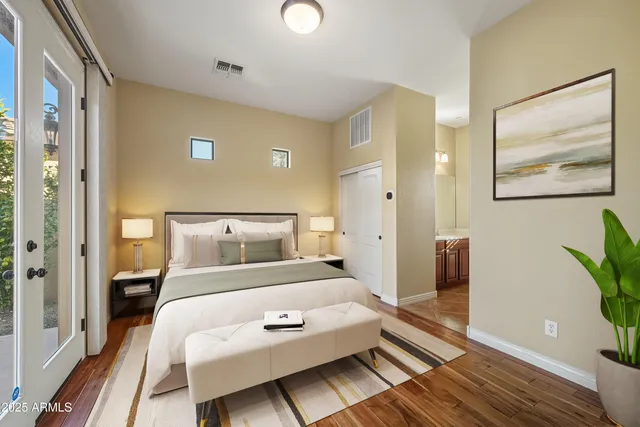 a bedroom with a bed and wooden floor