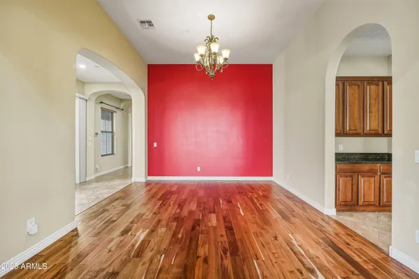 a view of a livingroom with wooden floor windows and chandelier