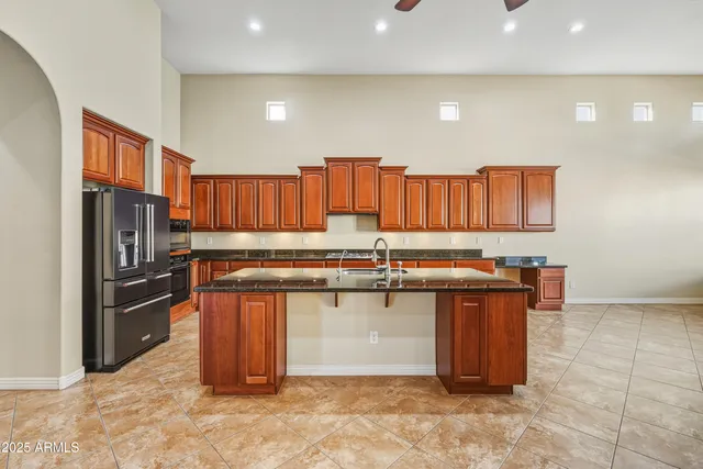 a kitchen with stainless steel appliances granite countertop a refrigerator and a sink
