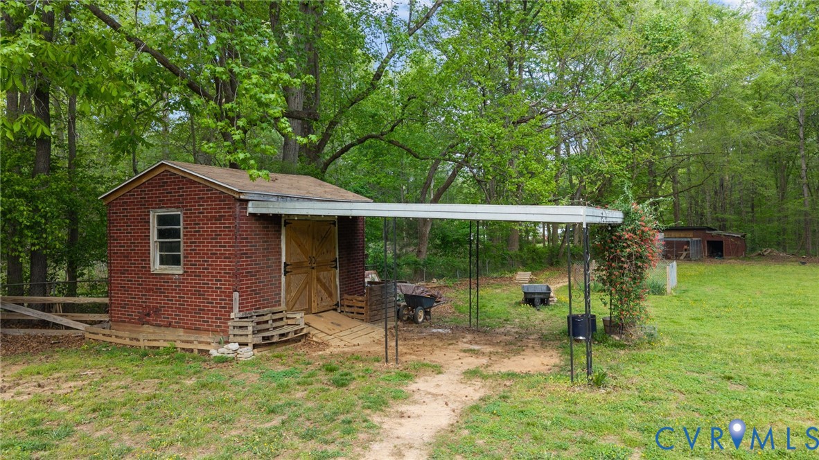 8141 Military Road Amelia Court House, VA 23002 - Photo 37 of 40 a backyard of a house with table and chairs