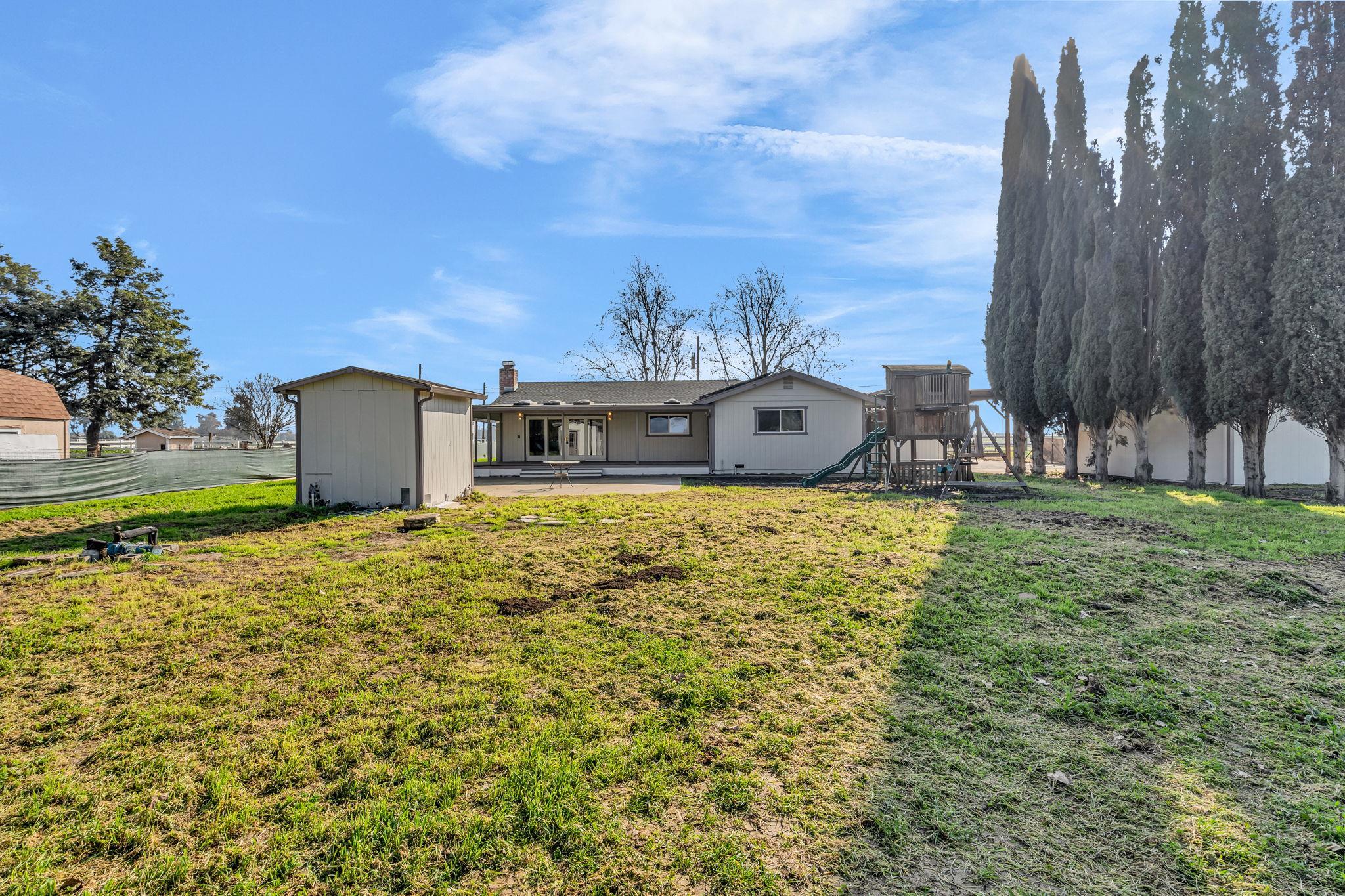 1660 Sunset Road Brentwood, CA 94513 - Photo 37 of 45 Rear view of house with a playground, a patio, a shed, and a chimney