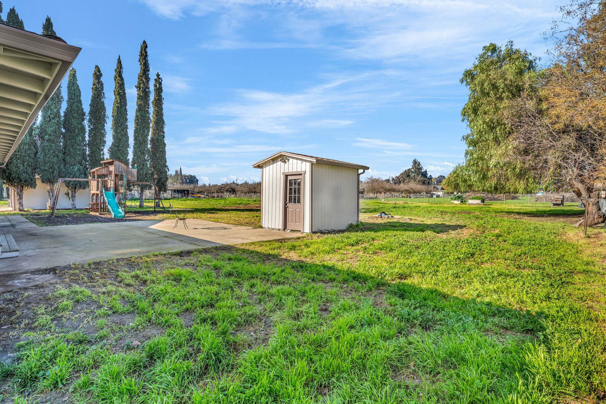 1660 Sunset Road Brentwood, CA 94513 - Photo 40 of 45 View of grassy yard with a playground and a storage unit