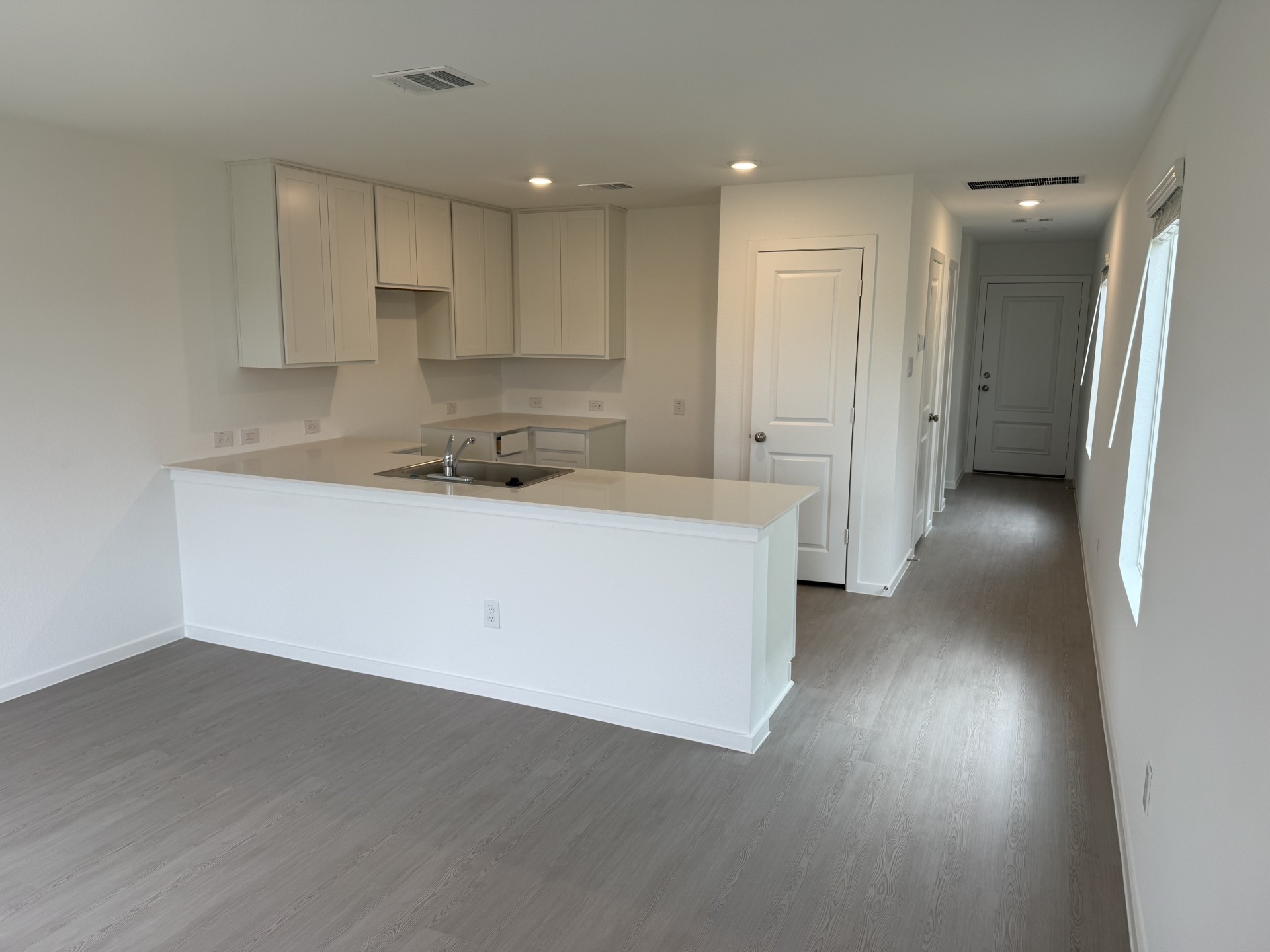 3607 Duplet Avenue Conroe, TX 77306 - Photo 4 of 27 a view of a kitchen with a sink and dishwasher a refrigerator with wooden floor