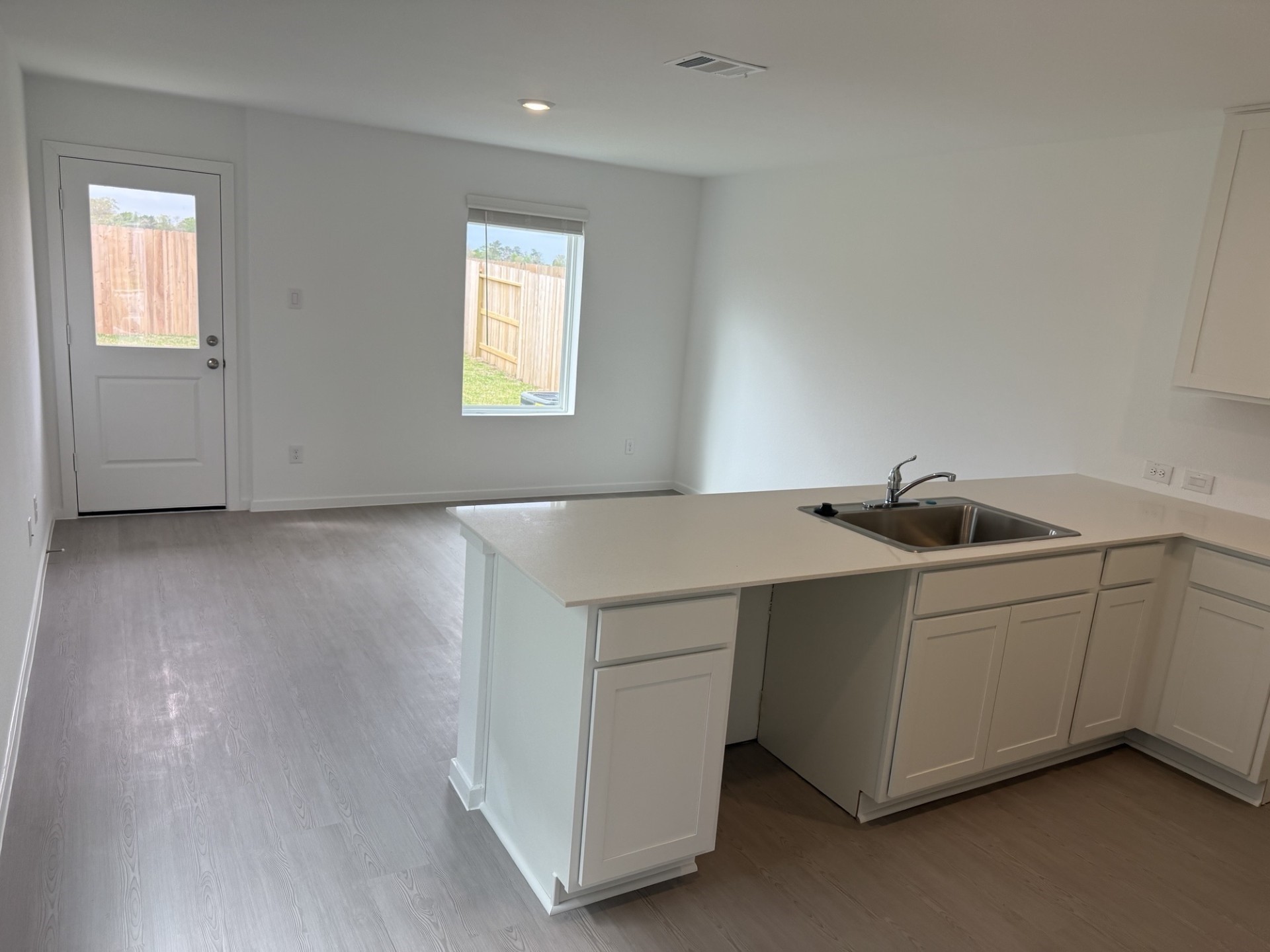3607 Duplet Avenue Conroe, TX 77306 - Photo 6 of 27 a utility room with washing machine and wooden floor