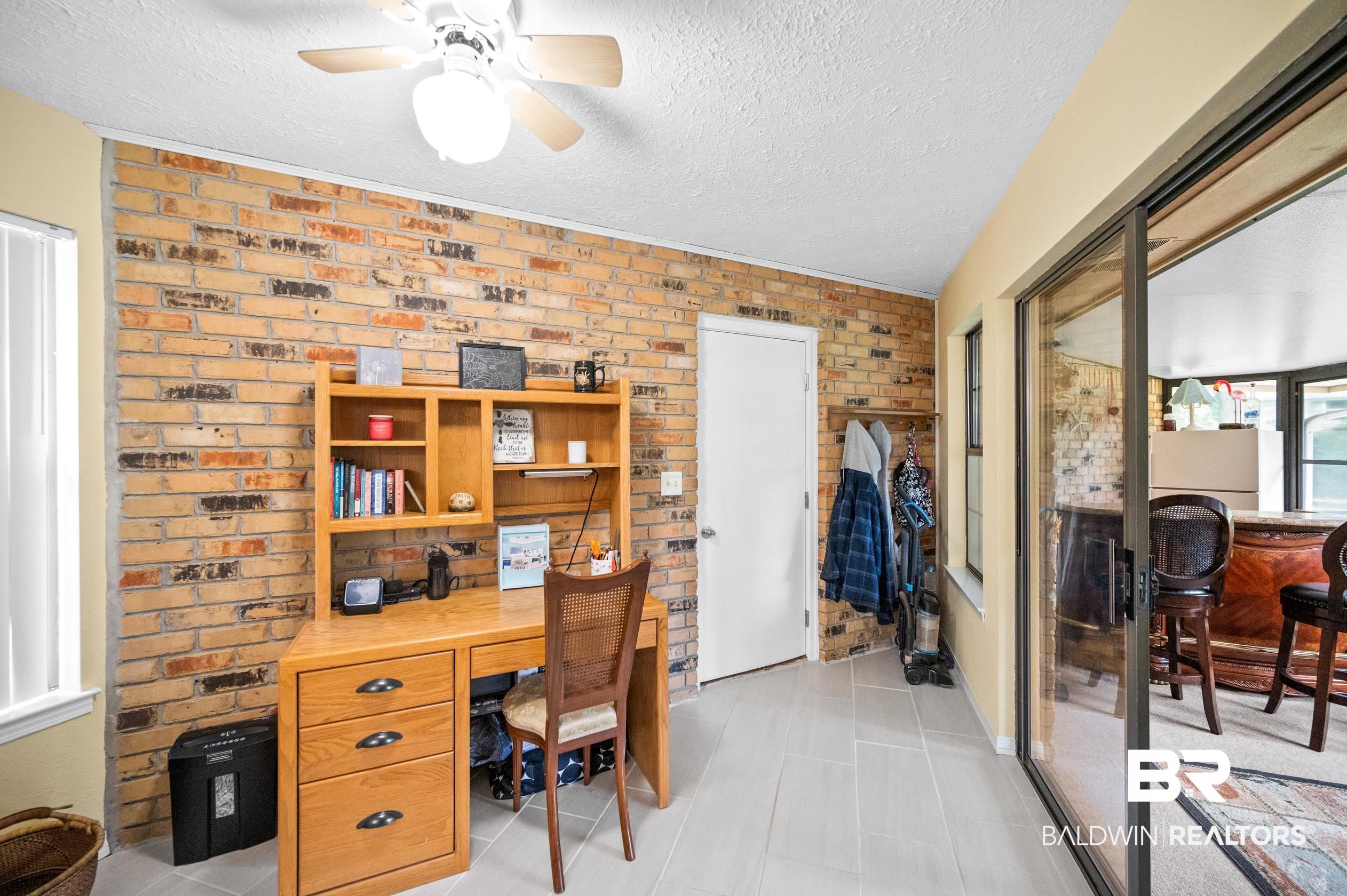 2772 Santa Rosa Circle Lillian, AL 36549 - Photo 24 of 50 Tiled office space featuring a textured ceiling, brick wall, and ceiling fan