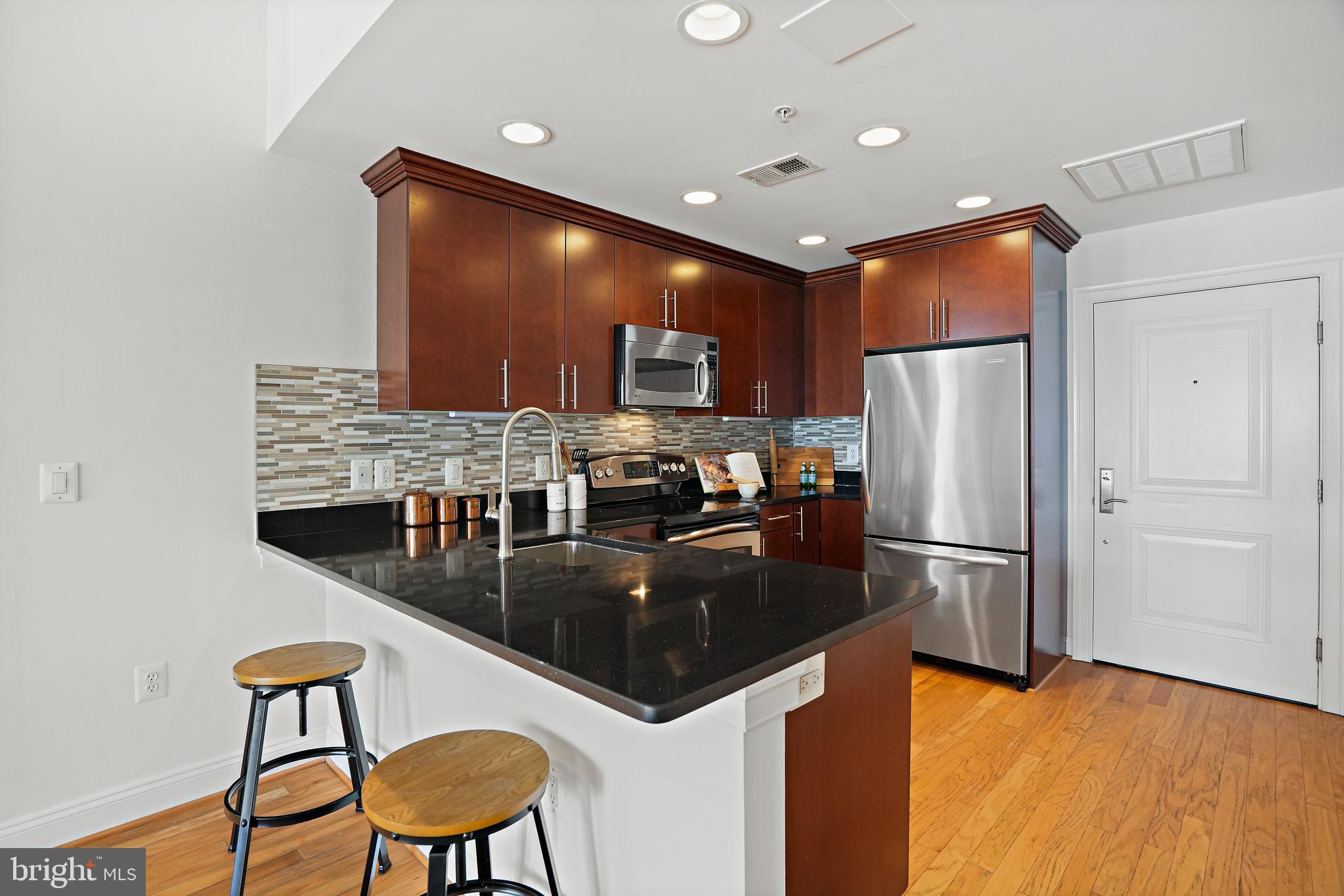 1407 W Street Northwest, Unit 201 Washington, DC 20009 - Photo 7 of 17 Kitchen with bar seating