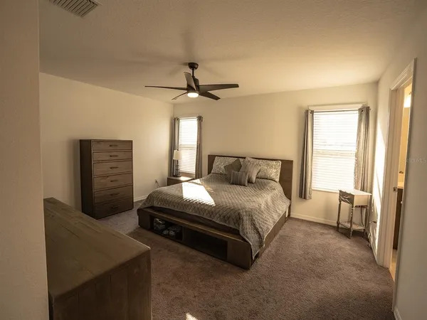a view of walk in closet with clothes