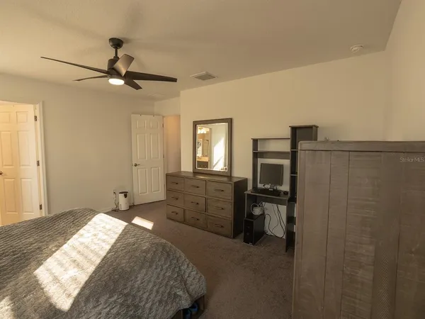 a spacious bathroom with a double vanity sink a mirror and a shower