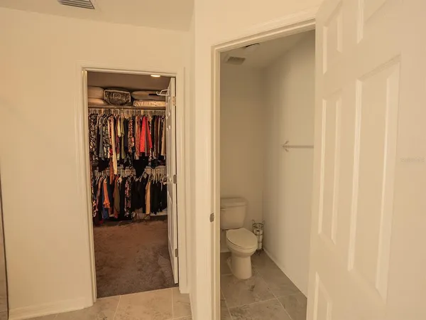 a bathroom with a glass door shower and a window