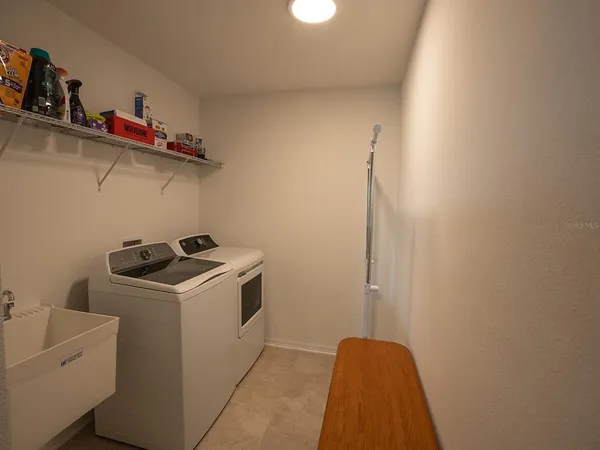 a view of a livingroom with workspace and a window