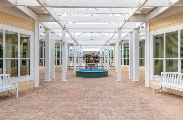 a view of a tennis ground with large trees