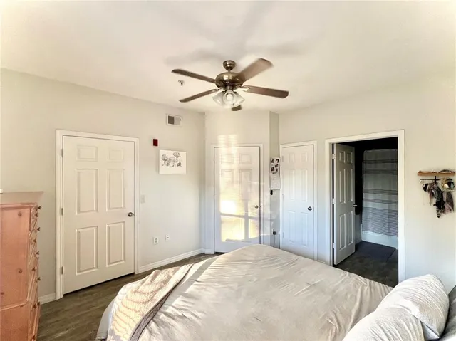 a bathroom with a toilet sink double vanity and mirror
