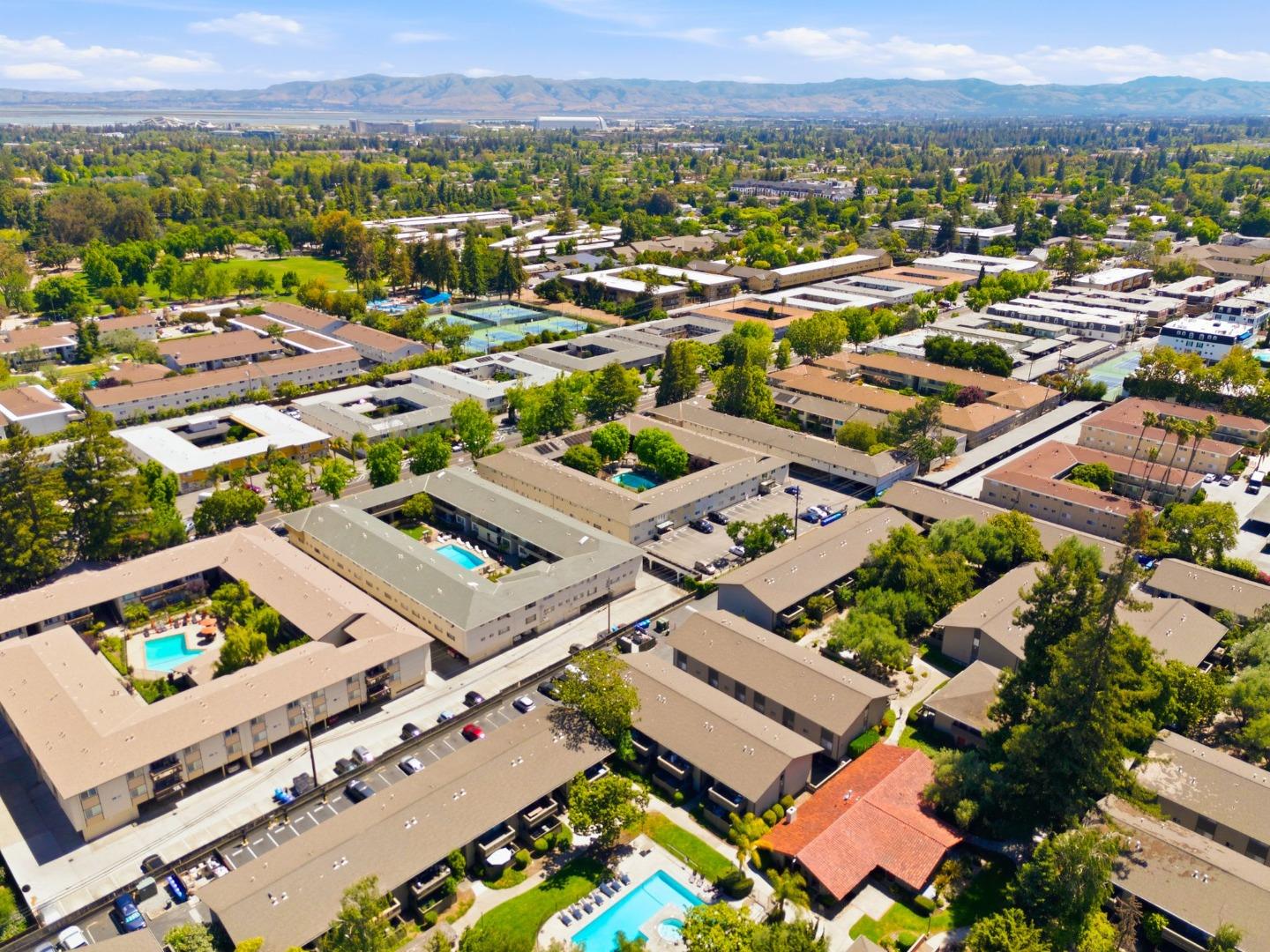 2025 California Street, Unit 40 Mountain View, CA 94040 - Photo 31 of 31 an aerial view of a city with lots of residential buildings and ocean view in back