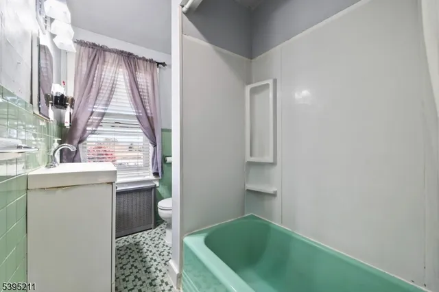 a bathroom with a sink a toilet and tub