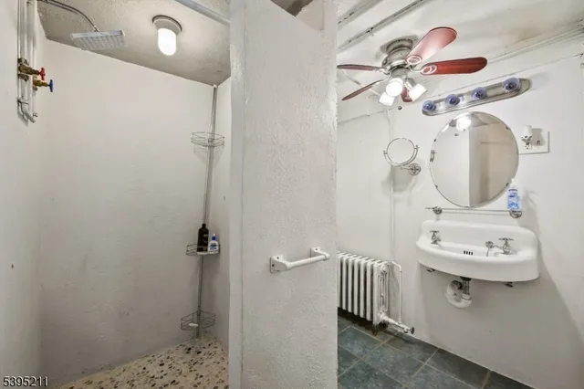 a bathroom with a sink a mirror and shower