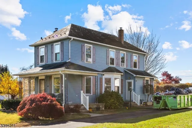 a front view of a house with yard and porch