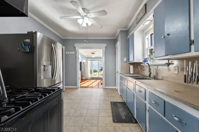 a large kitchen with stainless steel appliances granite countertop a sink stove and refrigerator