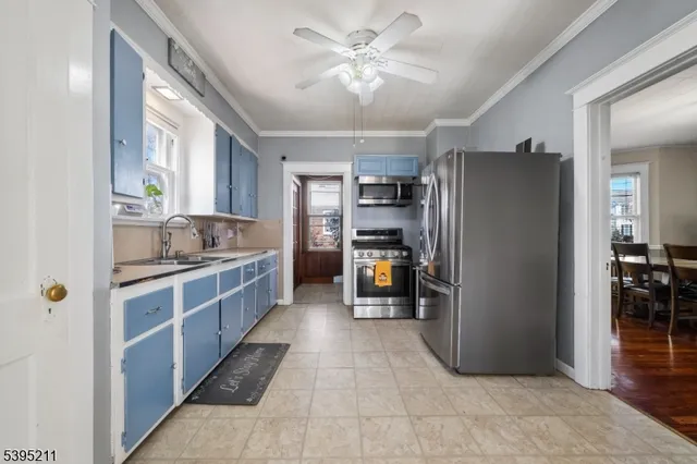 a kitchen with stainless steel appliances granite countertop a refrigerator and a sink