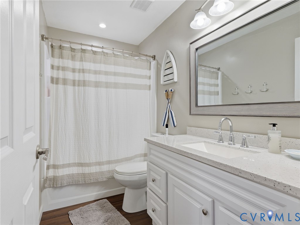 597 Harbor Drive Reedville, VA 22539 - Photo 17 of 34 Full bathroom featuring a white vanity with panel-