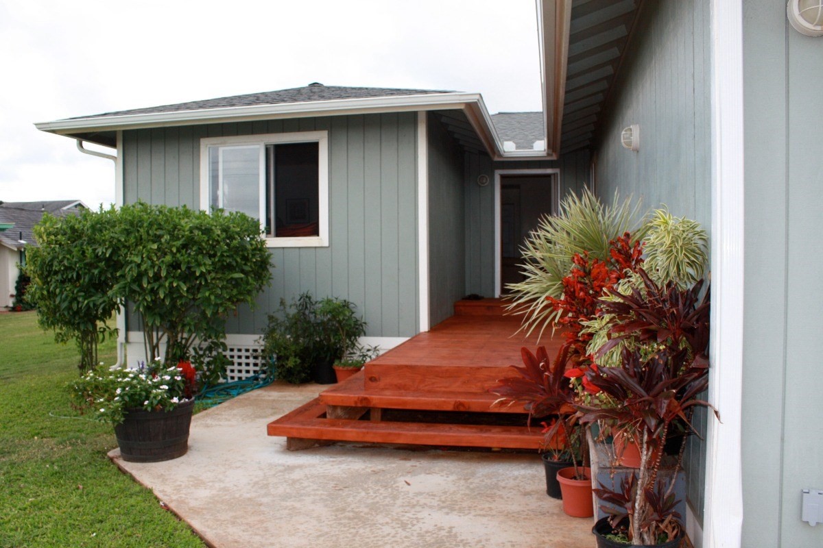 341 Eggerking Road, Unit 1 Kapaa, HI 96746 - Photo 5 of 10 a view of a house with a yard and potted plants