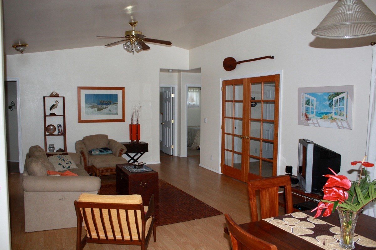 341 Eggerking Road, Unit 1 Kapaa, HI 96746 - Photo 9 of 10 a living room with furniture wooden floor and a fireplace