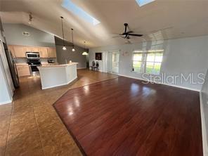 4 Pin Oak Drive Palm Coast, FL 32164 - Photo 5 of 15 a view of an empty room with kitchen appliances and a ceiling fan