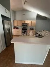 a kitchen with stainless steel appliances a refrigerator sink and microwave