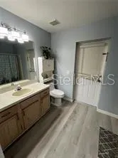 a bathroom with a double vanity sink toilet and shower