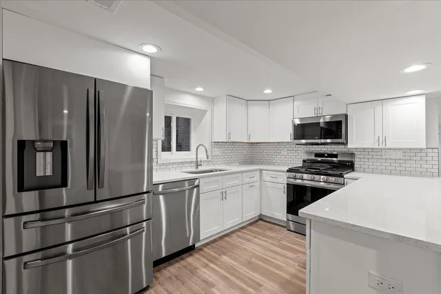 a kitchen with granite countertop stainless steel appliances and wooden cabinets