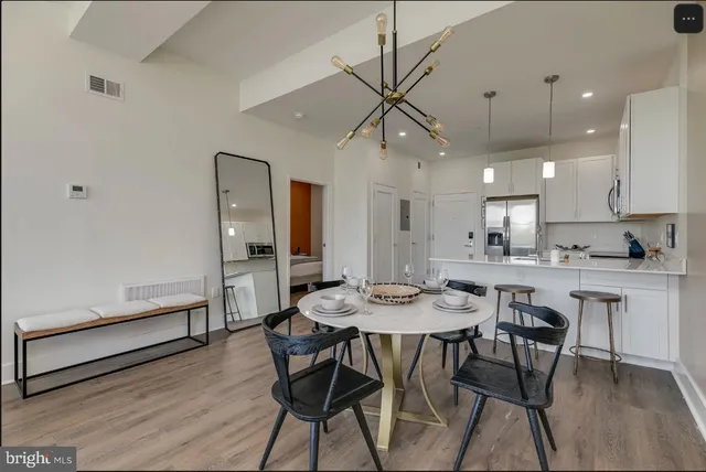 a view of a dining room with furniture window and wooden floor