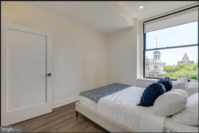 a bed sitting in a bedroom next to a window