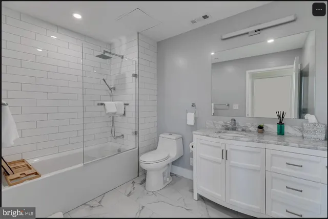 a bathroom with a double vanity sink toilet and shower