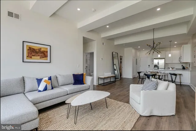 a living room with furniture and a painting