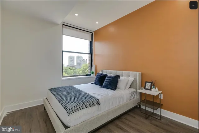 a bedroom with a bed and a window