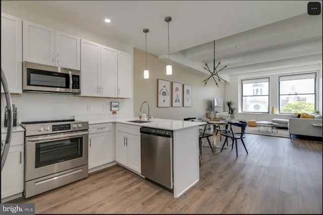 a kitchen with a stove a sink and microwave