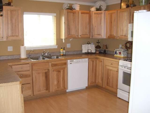 394 Evergreen Drive Rifle, CO 81650 - Photo 5 of 9 a kitchen with stainless steel appliances granite countertop a sink a stove a refrigerator with white cabinets