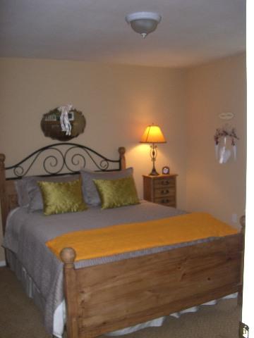 394 Evergreen Drive Rifle, CO 81650 - Photo 8 of 9 a bedroom with a bed and a lamp on dresser